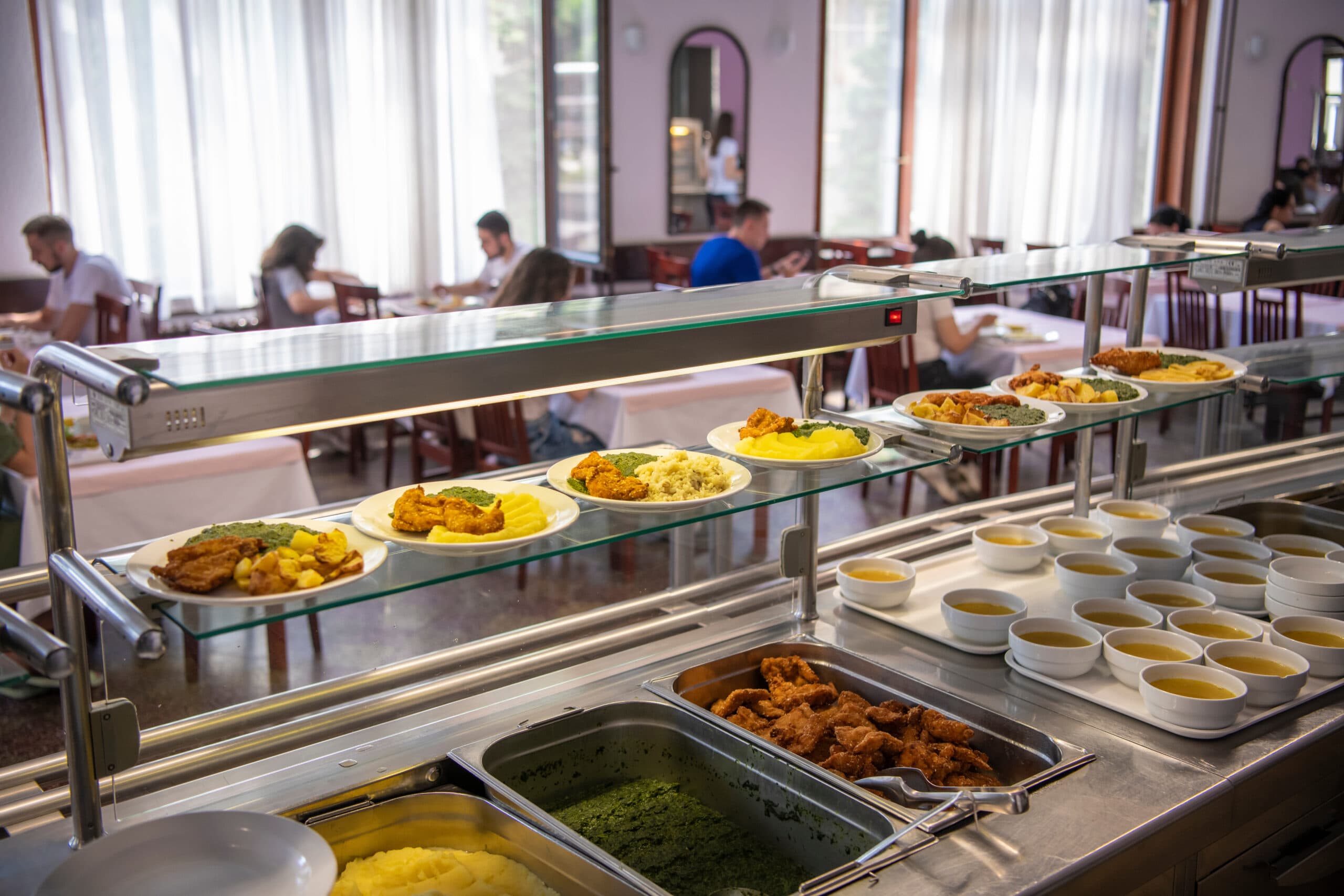 Students being served a meal in a campus canteen